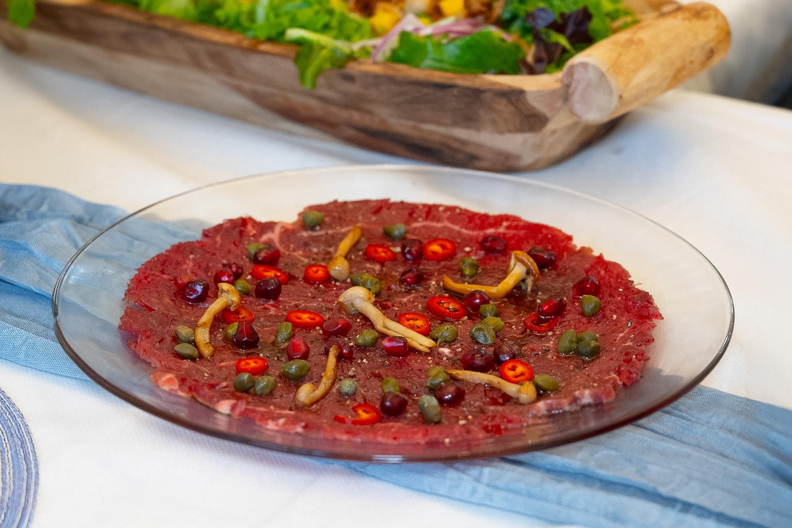 A carefully garnished carpaccio platter